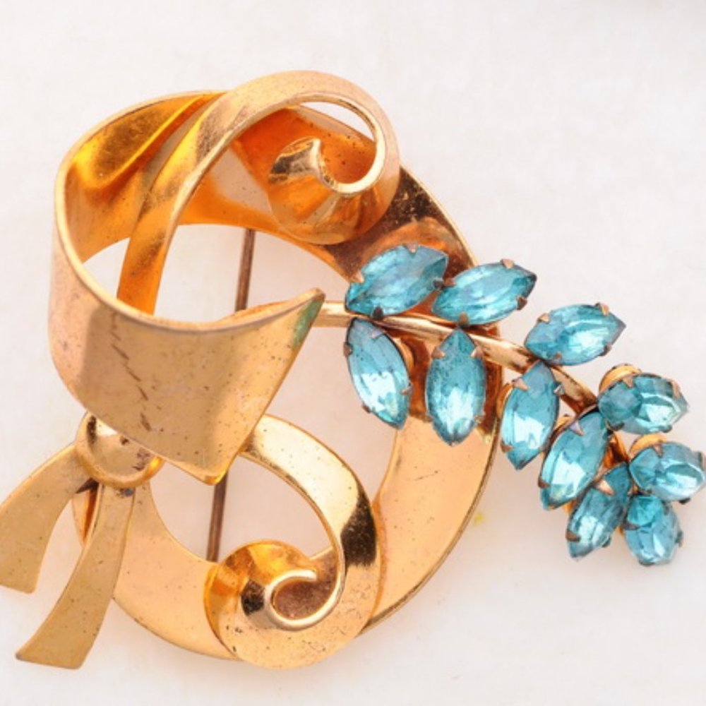 Gold tone ribbon pin with aqua rhinestones - -FREE with Purchase*